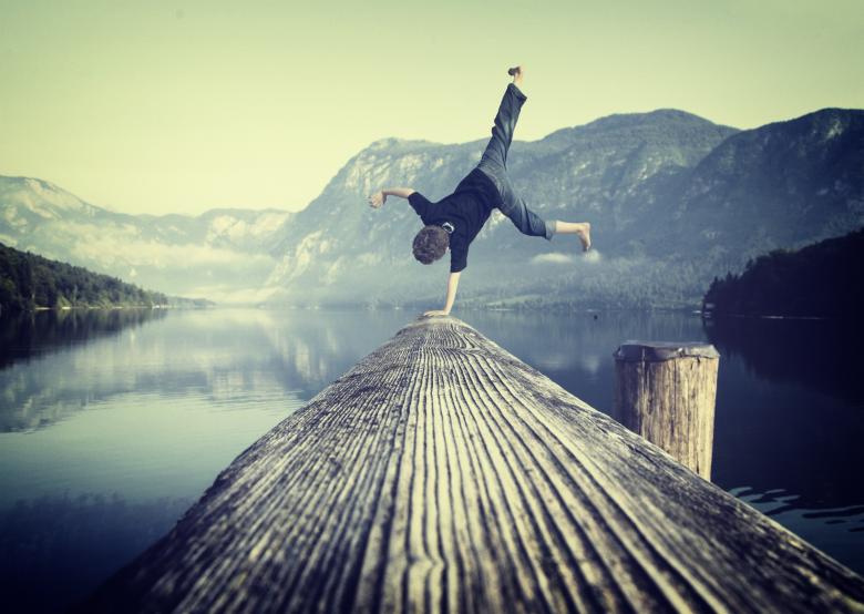 Free Stock Photo of Young boy handstanding on jetty Created by Jack Moreh